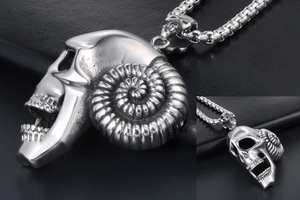 Macro detail of gothic ram skull pendant in polished steel with spiral horns