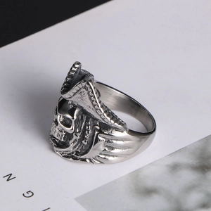 Macro detail of retro steel skull ring showing 3D pirate hat and relief textures