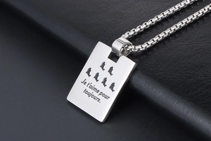 Close-up of titanium steel pendant engraved Je t'aime with fish hollow patterns