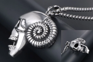 Macro detail of gothic ram skull pendant with spiral horns and stainless steel box chain