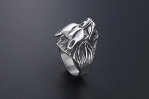 Macro detail of retro steel wolf head ring with intricate 3D embossed fur and punk style