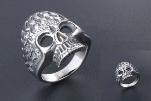 Macro detail of gothic skull ring with textured silver finish and realistic punk design
