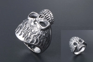 Macro detail of men's punk skull ring in titanium steel with intricate flame carvings