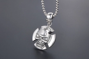 Close-up of gothic punk skull pendant in polished stainless steel with box chain