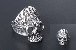 Macro view of men's punk skull ring with flame embossed textures and gothic hollow eyes