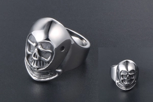 Macro view of men's gothic skull ring showing detailed stainless steel relief carving