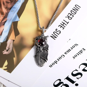 Titanium steel feather pendant necklace with ruby gemstone on a beaded silver chain