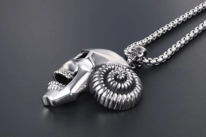Detailed side view of silver stainless steel ram horn skull pendant with gothic textures