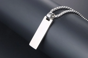 Detail of a matte silver rectangular pendant necklace with a sleek vertical box chain design