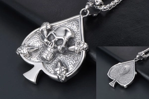 Macro detail of punk spade skull pendant showing intricate metal textures and carving