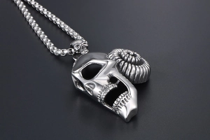 Macro detail of silver titanium steel ram horn skull pendant with stainless steel box chain