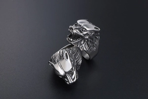 Detailed view of heavy punk style stainless steel wolf head rings in vintage silver