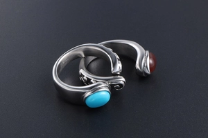 Detailed close-up of retro titanium steel rings with turquoise and agate inlay stones