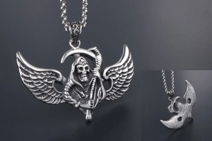 Detail of gothic grim reaper pendant with scythe and wings in retro silver steel