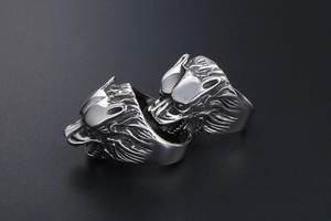 Detail of vintage wolf head rings with antique finish and intricate steel textures