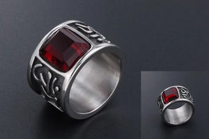 Detailed view of wide titanium steel ring featuring square red gemstone and ornate engraving