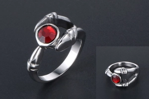 Detailed view of silver titanium ring featuring claw-set red gemstone and side stripes