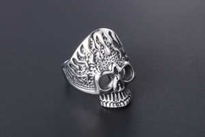 Macro shot of silver skull ring detail with flame textures and punk metal craftsmanship