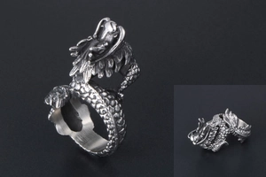 Macro detail of vintage silver dragon ring with intricate 3D embossed dragon scales