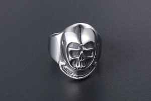 Macro shot of polished skull ring featuring vintage punk style and black oxidized details