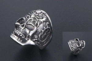 Macro detail of gothic skull ring with flame engraving and vintage silver finish