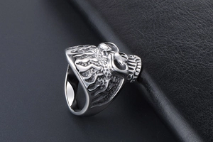 Detailed macro view of punk skull ring with intricate flame relief on polished steel