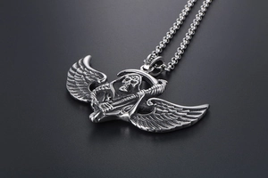 Macro shot of gothic winged grim reaper pendant in vintage silver titanium steel