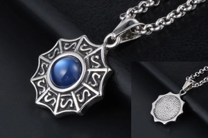 Détail macro du pendentif soleil rétro en titane avec pierre bleue et motifs gravés