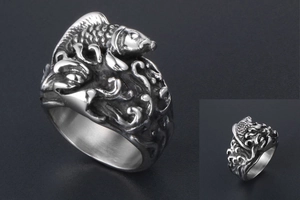 Macro shot of koi fish and ocean wave relief details on a vintage titanium steel ring