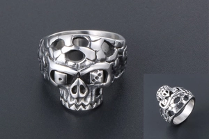 Detailed macro view of punk skull ring featuring unique dice eye sockets in steel finish