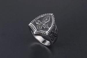 Close-up of vintage titanium steel shield ring featuring cross engraving and retro finish