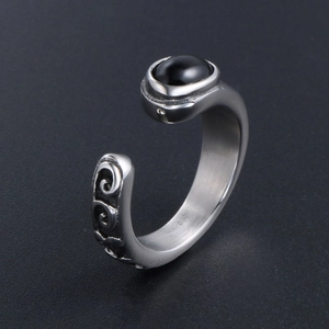 Retro titanium steel ring with black oval gemstone and vintage scrollwork texture