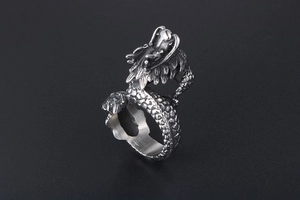 Macro detail of vintage silver dragon ring showing intricate scales and dragon head design