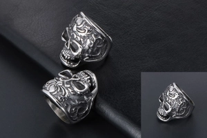 Macro detail of men's punk skull ring with gothic baroque vine engravings in vintage silver