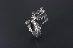 Detailed close-up of a vintage dragon ring with intricate scales and embossed textures