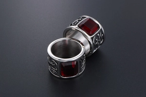 Macro shot of vintage titanium steel rings with wide bands and large red gemstones