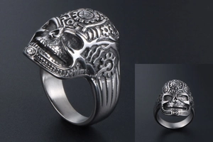 Macro detail of vintage skull ring featuring steampunk mechanical gears and star engraving