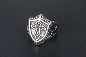 Detailed view of retro titanium steel shield ring featuring embossed cross and scrolls