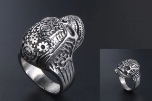 Detailed macro view of vintage skull ring featuring steampunk mechanical gears and dark silver finish