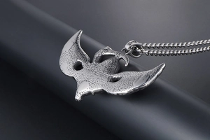 Macro view of flying eagle punk pendant with vintage texture and bead chain