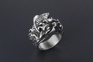 Macro detail of retro koi fish and wave patterns on a vintage titanium steel ring