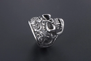 Detailed side view showing intricate vine patterns on the vintage silver skull ring