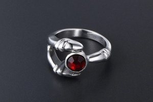 Gothic silver ring featuring a central red crystal held by a vintage claw setting