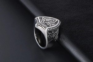 Detailed view of retro titanium steel ring featuring cross emblem and gothic carvings