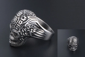 Macro detail of retro punk skull ring featuring industrial gear patterns and aged steel finish