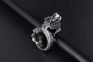 Macro detail of silver dragon ring featuring intricate scales and punk retro carving