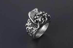 Macro view of retro titanium steel ring featuring layered high-relief wave textures