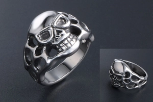 Macro shot of gothic skull ring in silver titanium steel with hollowed detail