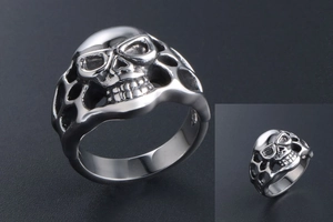 Macro view of gothic skull ring with intricate hollow details and polished silver finish