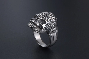 Detailed macro shot of vintage skull ring with mechanical gear and ROCK engraving